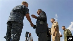 U.S. Defense Secretary Leon Panetta greets personnel while visiting the Sigonella Naval Air Station and NATO regional operations center, in Sigonella, Italy, October 7, 2011.