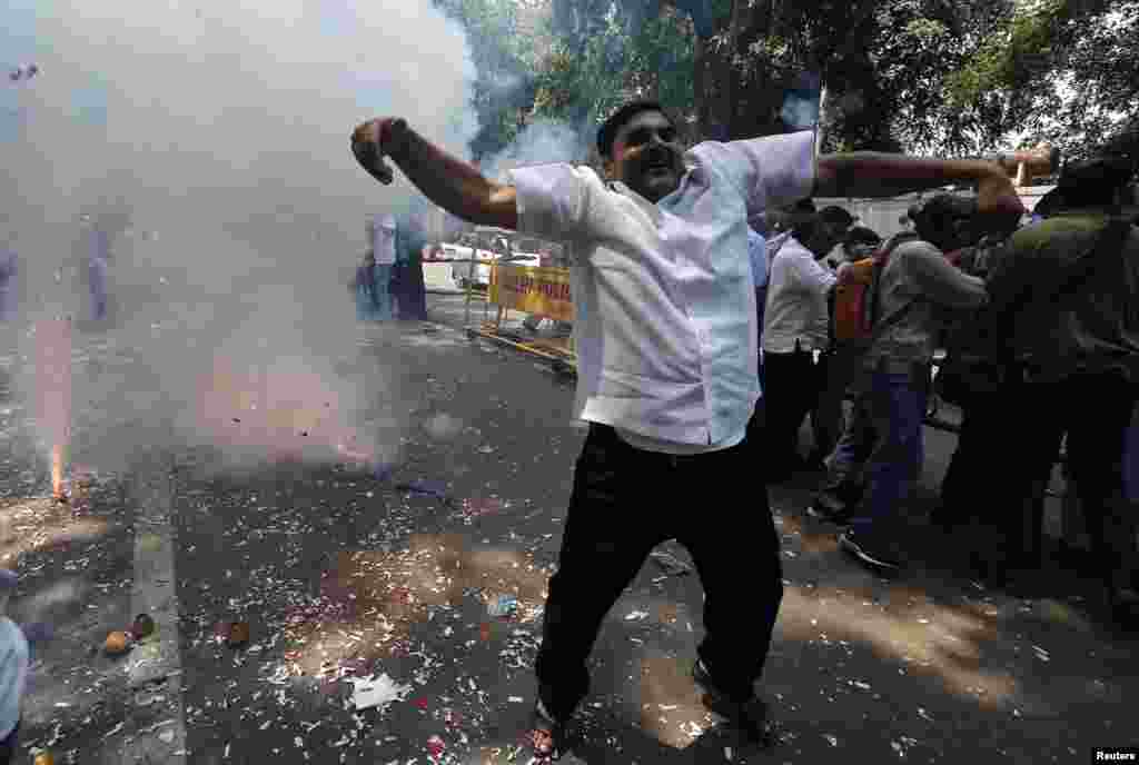 A supporter of India&#39;s Bharatiya Janata Party (BJP) celebrates after learning of the early poll results outside&nbsp; party headquarters in New Delhi, May 16, 2014.