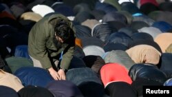 FILE - Muslim demonstrators pray during a protest in central London that followed publication of cartoons depicting the Prophet Muhammad in the French magazine Charlie Hebdo, Feb. 8, 2015. 