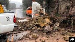 This photo provided by the California Department of Transportation (Caltrans) shows debris from a rock slide in the middle of Topanga Canyon Road in Los Angeles after a heavy rainstorm swept through Jan. 17, 2019.