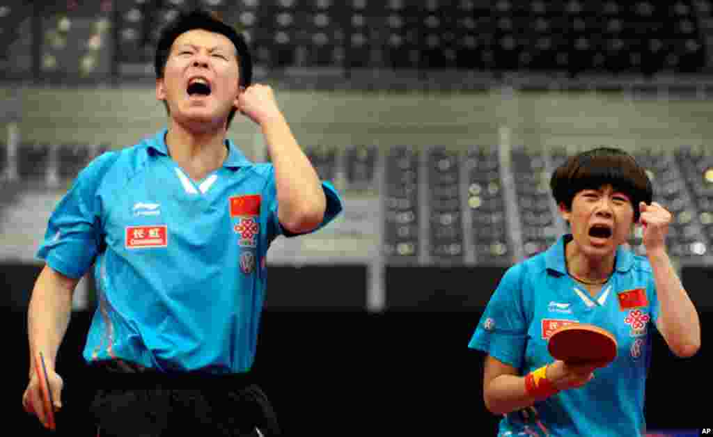 May 13: Zhang Chao (L) and Cao Zhen of China during their mixed doubles final at the World Table Tennis Championships in Rotterdam. (REUTERS/Robin van Lonkhuijsen)