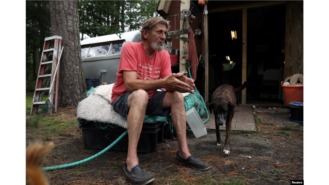 Karroll "Frog" Tilllett poses outside his workshop near his trailer in Wanchese, North Carolina, May 31, 2017.