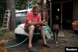 Karroll "Frog" Tilllett poses outside his workshop near his trailer in Wanchese, North Carolina, May 31, 2017.