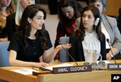 While Nadia Murad, right, listens, Amal Clooney speaks during a Security Council meeting on sexual violence, at the United Nations headquarters, April 23, 2019.