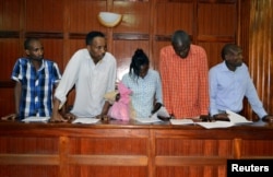 Suspects, left to right, Osman Ibrahim, Oliver Muthee, Gladys Kaari, Guled Abdihakim and Joel Nganga stand in the dock inside the Mililani Law Courts where they appeared in connection with the attack at the DusitD2 complex, in Nairobi, Kenya, Jan. 18, 2019.