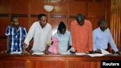 Suspects, left to right, Osman Ibrahim, Oliver Muthee, Gladys Kaari, Guled Abdihakim and Joel Nganga stand in the dock inside the Mililani Law Courts where they appeared in connection with the attack at the DusitD2 complex, in Nairobi, Kenya, Jan. 18, 2019.