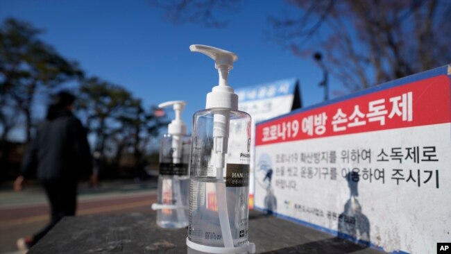 Bottles of hand sanitizer are placed for public use to prevent from the coronavirus at a park in Goyang, South Korea, Dec. 4, 2021. South Korea again broke its daily records for coronavirus infections and deaths.