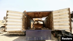 A tank gun hidden inside a truck, made by Islamic State militants, to avoid attack from planes are seen at Federal Police Headquarters after being confiscated in Mosul, Iraq July 13, 2017.