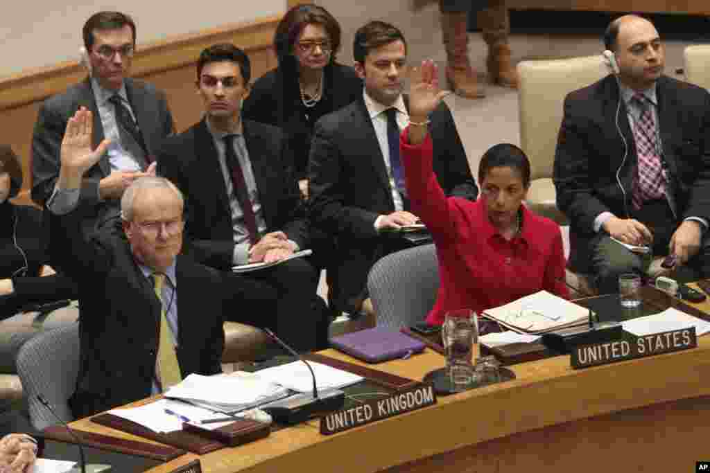 U.S. Ambassador to the United Nations Susan Rice, and British Ambassador Mark Lyall Grant,vote to support a resolution backing an Arab League call for Syrian President Bashar Assad to step down, New York, February 4, 2012. 