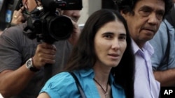 Yoani Sanchez, who writes the "Generation Y" blog, center, walks with her husband Reinaldo Escobar in Havana, Cuba, Wednesday March 30, 2011. (AP Photo/Franklin Reyes)