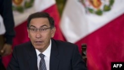 Peruvian President Martin Vizcarra gestures as he speaks, during a press conference with representatives of foreign media in Lima, June 5, 2018. 