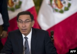 FILE - Peruvian President Martin Vizcarra gestures as he speaks, during a press conference with representatives of foreign media in Lima, June 5, 2018.
