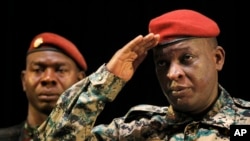 FILE - Guinea's General Sekouba Konate salutes after addressing presidential candidates and elections officials in this 2010 photo. Konate faces up to five years in prison for smuggling tens of thousands of dollars into the US.