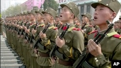 In this image made from video broadcast by North Korean broadcaster KRT, soldiers take part in a parade at Kim Il Sung Square in Pyongyang, April 15, 2017. North Korean leader Kim Jong Un has appeared in a massive parade in the capital, Pyongyang, celebra