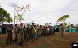 Revolutionary Armed Forces of Colombia, FARC, gather at their camp in La Carmelita near Puerto Asis in Colombia's southwestern state of Putumayo, Wednesday, March 1, 2017. March 1 was the deadline for the FARC to turn over 30 percent of their arms. But logistical delays setting up the rural camps where rebels are gathered has slowed the process.