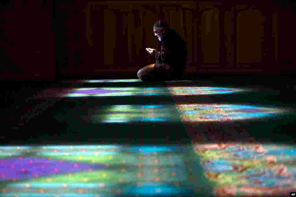 A Crimean Tatar man prays at a mosque in Bakhchysarai, Ukraine. The arrival of Russian troops in Crimea has opened old wounds among the Crimean Tatars, who once again fear they will be unwelcome in their homeland. This time, however, some are organizing community watch patrols to protect their families and homes in what they still consider part of Ukraine.