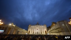 Faithful wait for the result of the first vote during a papal election conclave at St Peter's square at the Vatican, March 12, 2013.