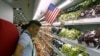 FILE - A man stands at a fruit section of a supermarket in Hanoi, Vietnam, Sept. 20, 2014. 