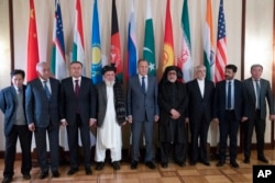 Russian Foreign Minister Sergey Lavrov (C) poses for a photo with the participants of the conference on Afghanistan bringing together representatives of the Afghan authorities and the Taliban in Moscow, Russia, Nov. 9, 2018.