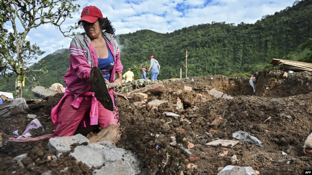 A woman searches for victims after a landslide in Rosas, Cauca department, in southwestern Colombia, April 22, 2019.