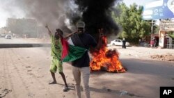 Protesters call for a civilian government during demonstrations near the presidential palace in Khartoum, Sudan, Nov. 30, 2021. 