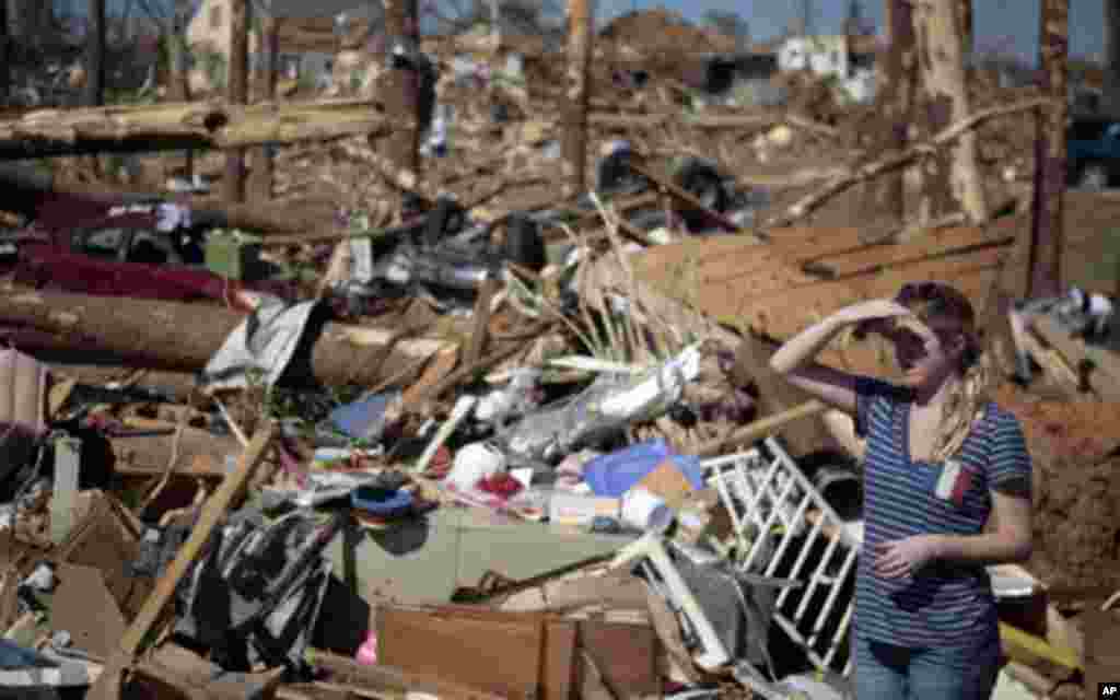 A woman looks over devastation in the aftermath of deadly tornados in Tuscaloosa, Alabama April 28, 2011. Tornadoes and violent storms ripped through seven Southern states, killing at least 295 people and causing billions of dollars of damage in some of t