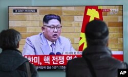 FILE - South Koreans watch a TV news program showing North Korean leader Kim Jong Un's New Year's address, at the Seoul Railway Station in Seoul, South Korea, Jan. 1, 2018.