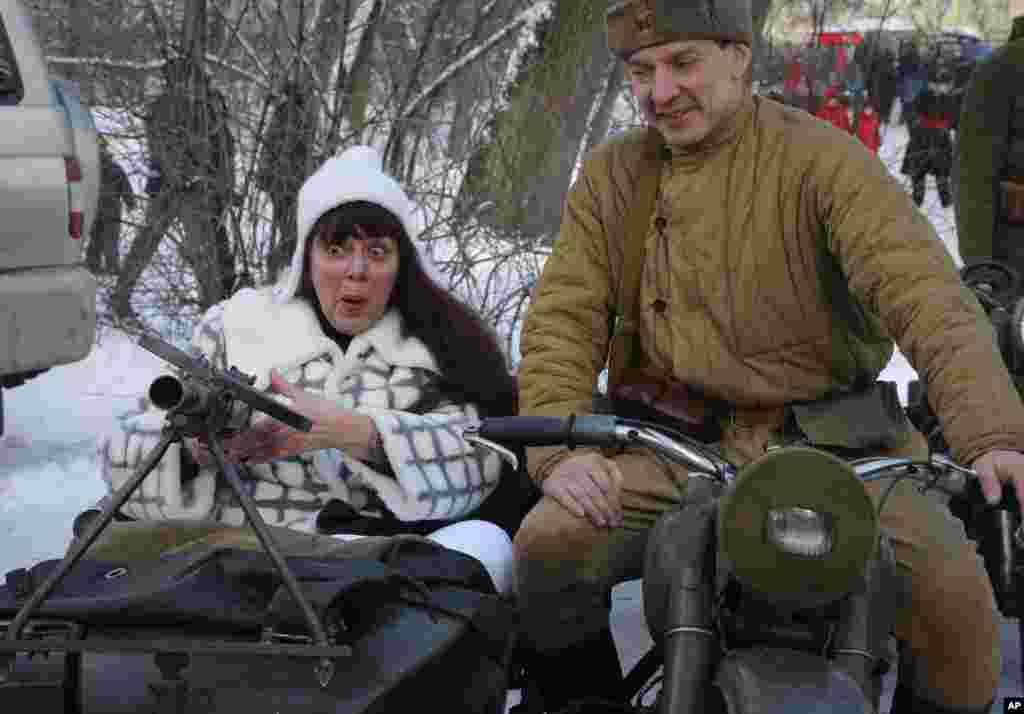 A woman aims a World War II machine gun during a celebration of the Defenders of the Fatherland Day in St.Petersburg, Russia.