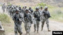 FILE - U.S. Army soldiers conduct an ambush drill inside a Philippine army camp in Fort Magsaysay, north of Manila, April 21, 2012. The base is one of five agreed-on locations for American military forces to be able to access under a security deal.