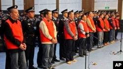 In this photo taken Oct. 12, 2009, Yang Tianqing, first left, and other unidentified suspects allegedly ivolved in mafia-style gangs stand trial at the Chongqing No.1 Intermediate People's Court in Chongqing, China. 
