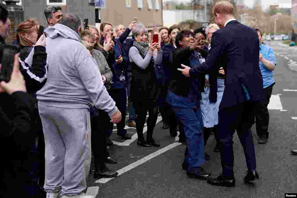Britain&#39;s Prince Harry, Duke of Sussex, is greeted by staff and well-wishers as he leaves The Institute of Translational Medicine at Queen Elizabeth Hospital, in Birmingham.