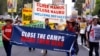 FILE - Refugee advocates protest in Sydney, Oct. 15, 2017, against the treatment of asylum-seekers in detention centers in Nauru and on Manus Island.