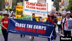 FILE - Refugee advocates protest in Sydney, Oct. 15, 2017, against the treatment of asylum-seekers in detention centers in Nauru and on Manus Island.