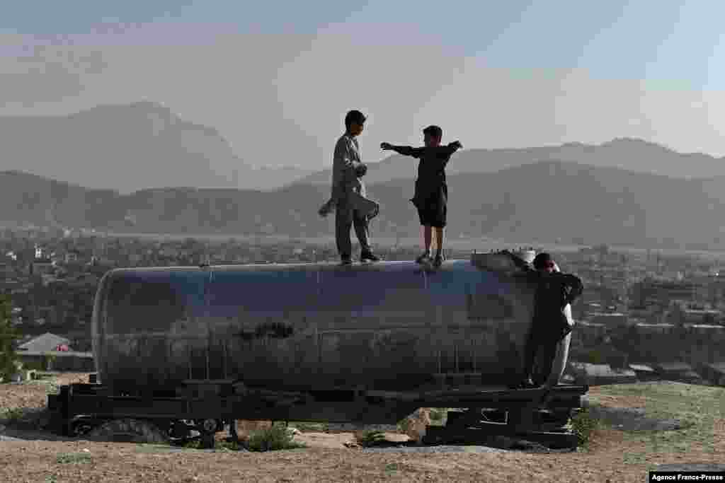 Boys play on a water tanker at Nadir Khan hilltop overlooking Kabul, Afghanistan.