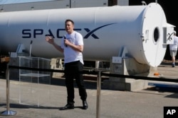 FILE - Telsa CEO Elon Musk congratulates the winners of the Hyperloop Pod Competition II at SpaceX's Hyperloop track in Hawthorne, Calif., Sunday, Aug. 27, 2017.