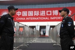 Security guards stand on duty near an entrance to the China International Import Expo in Shanghai, November 5, 2018.