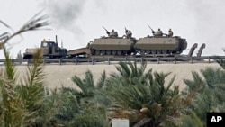 Armored personnel carriers are transported on the flyover near the Bahrain Saudi bridge in Manama Mar 15 2011