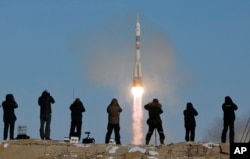 FILE - The Soyuz-FG rocket booster with Soyuz MS-07 spaceship, carrying a new crew to the International Space Station, blasts off at the Russian-leased Baikonur cosmodrome, Kazakhstan, Dec. 17, 2017.