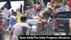 FILE - A vehicle plows into a group of protesters in Charlottesville, Virginia, Aug. 12, 2017.