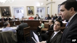 Representative Henry Cuellar, right, walks into the House Rules Committee meeting, on Capitol Hill in Washington, regarding floor debate on legislation that would repeal the health care overhaul bill, 6 Jan 2011