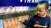 FILE - A Vietnamese boy looks at dairy products at a showroom of the Vietnam Dairy Products Co (Vinamilk) in Hanoi.