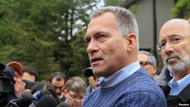 Wendell Hissrich, Pittsburgh public safety director, speaks to media as Pennsylvania Governor Tom Wolf, right, looks on after a gunman opened fire at the Tree of Life synagogue in Pittsburgh, Pa., Oct. 27, 2018.