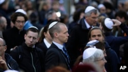 FILE - People wear Jewish skullcaps - or kippas, as they attend a demonstration against an anti-Semitic attack, in Berlin, Germany, April 25, 2018.