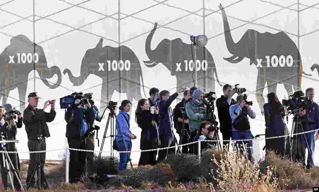 Members of the media cover a U.S. Fish and Wildlife Service event in which confiscated elephant ivory was destroyed at the National Wildlife Property Repository, Commerce City, Colo., Nov. 14, 2013. 