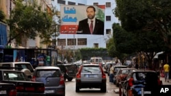 A poster of outgoing Prime Minister Saad Hariri hangs on a street in Beirut, Lebanon, Nov. 6, 2017. 