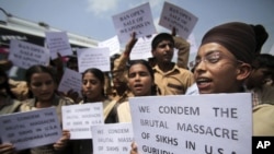 Indian school children hold placards and shout slogans during a protest against the deadly shooting attack at a Sikh temple in Wisconsin, in Jammu, Aug. 6, 2012. 