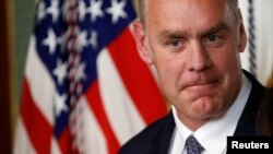 Ryan Zinke pauses after he was sworn in to be Secretary of the Interior in Washington, March 1, 2017. 
