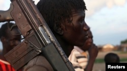 A man from the Lou Nuer tribe carries his gun in Yuai Uror county, South Sudan, July 24, 2013.