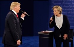 FILE - In this Sunday, Oct. 9, 2016, file photo, Republican presidential nominee Donald Trump and Democratic presidential nominee Hillary Clinton speak during the second presidential debate at Washington University in St. Louis