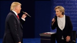 FILE - In this Sunday, Oct. 9, 2016, file photo, Republican presidential nominee Donald Trump and Democratic presidential nominee Hillary Clinton speak during the second presidential debate at Washington University in St. Louis